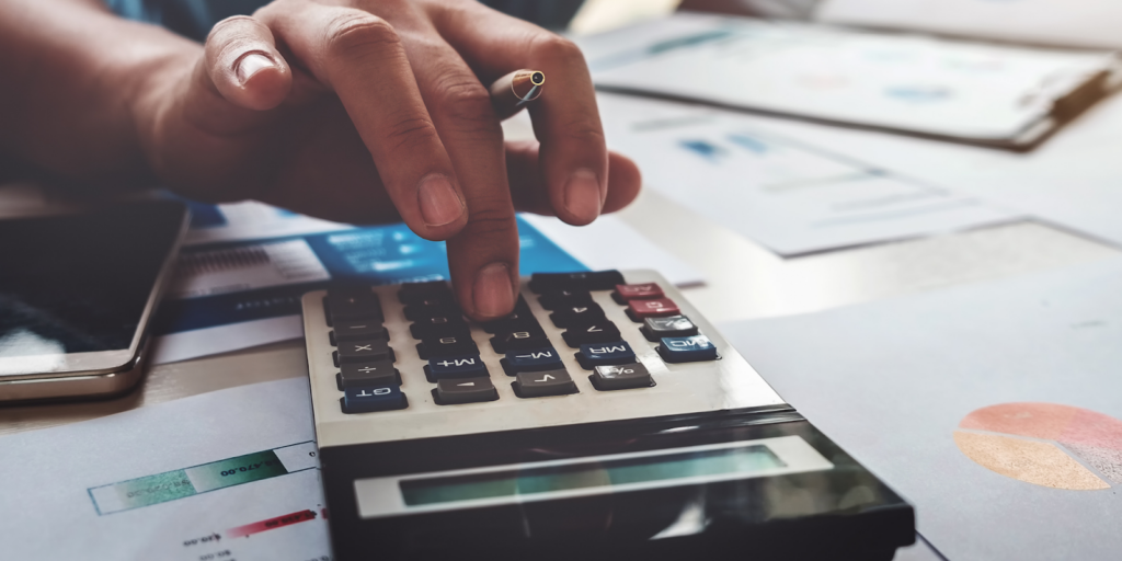 Business man using calculator with computer laptop