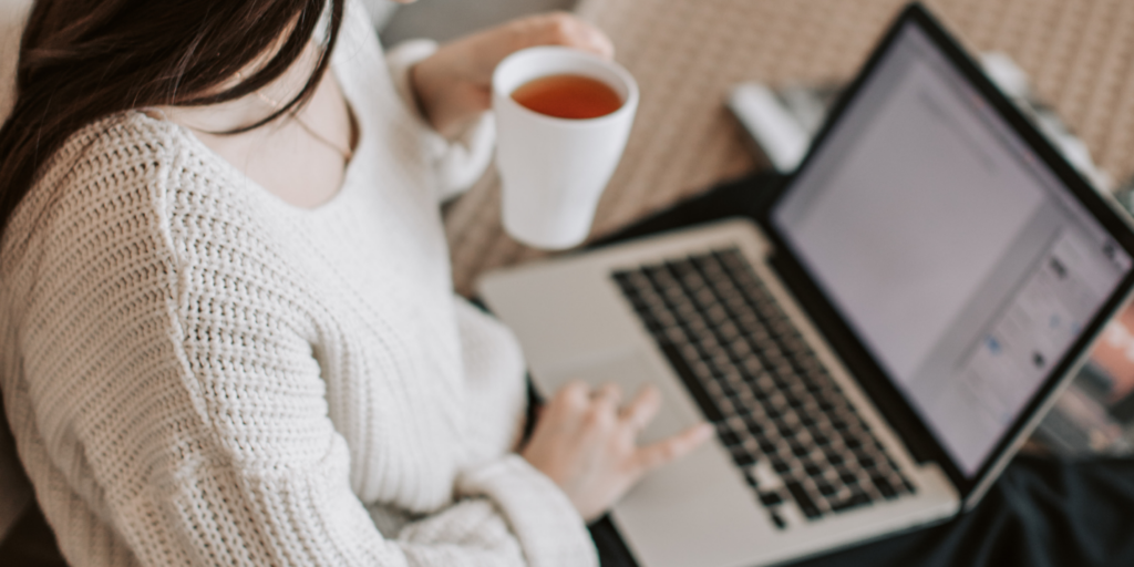 Woman working on laptop on floor